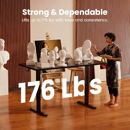 Artist using adjustable table to hold sculptures.