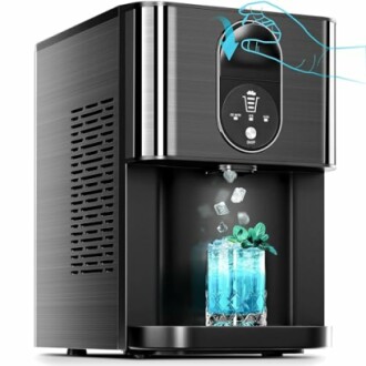 Countertop ice maker dispensing ice into a glass with blue liquid and mint garnish.