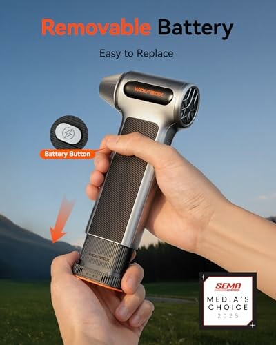 Hands holding a massage gun with removable battery feature highlighted.